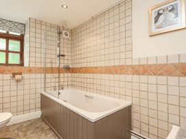 A bathroom with a bathtub and shower at The Coach House in Kingston