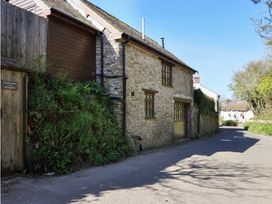 A house exterior with plants and a road at The Coach House in Kingston