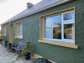 An outdoor area with a bench and windows at Sea View Hideaway in Lahinch, County Clare