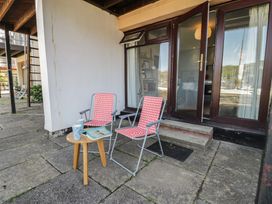 A patio with chairs and a table at 56C South Snowdon Wharf in Porthmadog