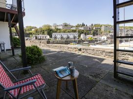 An outdoor seating area with a table and cups at 56C South Snowdon Wharf in Porthmadog