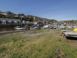 A view of boats in a marina with buildings and grass at 56C South Snowdon Wharf Porthmadog