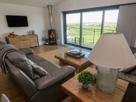 A living room with a sofa and coffee table at Sandpiper in Perranporth