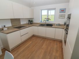 A kitchen with sink and countertop at Sandpiper in Perranporth
