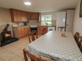 A kitchen with a dining table and appliances at Shaws Hill Farmhouse, Kells, County Antrim