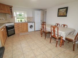 A dining room with a table and chairs at Shaws Hill Farmhouse, Kells, County Antrim