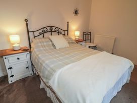 A bedroom with a bed and bedside tables at Shaws Hill Farmhouse, Kells, County Antrim