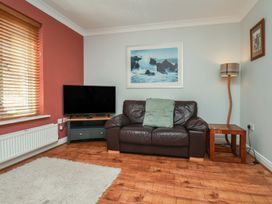 A living room with a TV and sofa at Tides Reach in Whitby