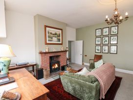 A living room with a sofa and fireplace at 20A St Hilda's Whitby