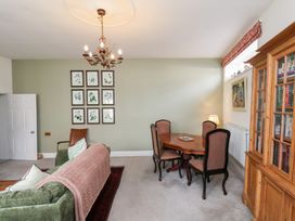 A living room with a sofa and dining table at 20A St Hilda's in Whitby