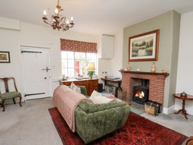 A living room with a fireplace and seating area at 20A St Hilda's Whitby