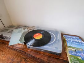 A record player with a vinyl record and magazines at 20A St Hilda's in Whitby