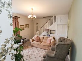 A living room with a sofa and armchair at 20A St Hilda's in Whitby