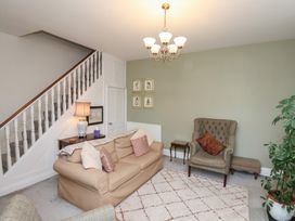 A living room with a sofa and armchair at 20A St Hilda's in Whitby