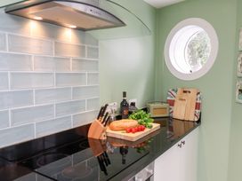 A kitchen with a black countertop and food preparation area at 20A St Hilda's in Whitby