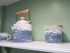 A kettle and container on a shelf at 20A St Hilda's, Whitby