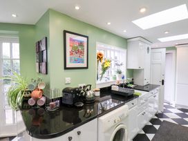 A kitchen with appliances and a window at 20A St Hilda's in Whitby