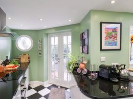 A kitchen with a countertop and a door leading outside at 20A St Hilda's in Whitby