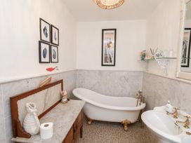 A bathroom with a bathtub and sink at 20A St Hilda's Whitby