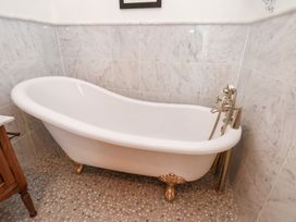 A bathroom with a freestanding bathtub at 20A St Hilda's, Whitby