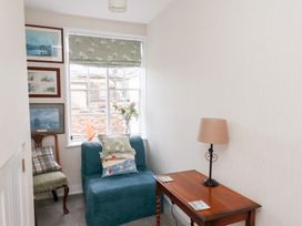 A hallway with a chair and a table at 20A St Hilda's in Whitby