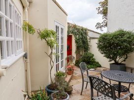 A garden space with a table and chairs at 20A St Hilda's in Whitby