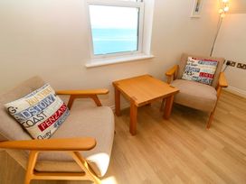 A living room with two armchairs and a coffee table at Meridian in Carbis Bay