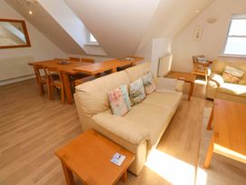 A living room with a sofa and dining table at Meridian in Carbis Bay