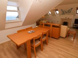 A living room with dining furniture and window in Meridian, Carbis Bay