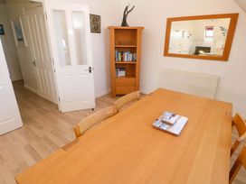 A dining room with a table and bookshelf at Meridian in Carbis Bay
