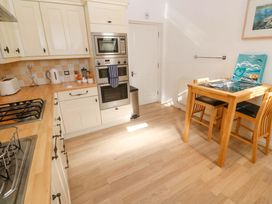 A kitchen with appliances and a table at Meridian in Carbis Bay