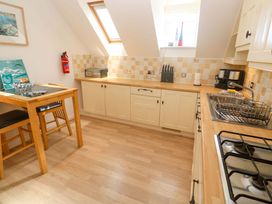 A kitchen with a table and stools at Meridian in Carbis Bay