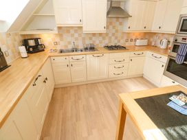 A kitchen with cabinets and appliances at Meridian in Carbis Bay