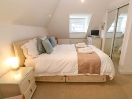 A bedroom with a bed and television at Meridian in Carbis Bay