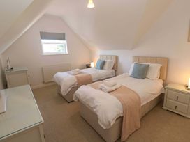 A bedroom with two beds and a television at Meridian in Carbis Bay