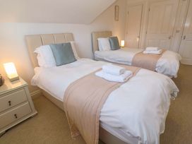 A bedroom with two beds and a nightstand at Meridian in Carbis Bay