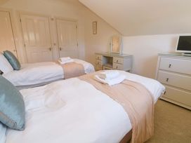 A bedroom with two beds and a dresser at Meridian in Carbis Bay