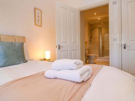 A bedroom with a bed and towels at Meridian in Carbis Bay