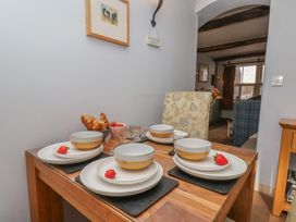 A dining table set with plates and fruits at Cobbles House, Whitby