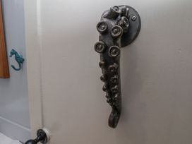 A door handle shaped like an octopus tentacle at Cobbles House in Whitby