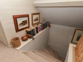 A stairwell with books and frames at Cobbles House in Whitby