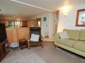 A living room with a television and sofa at Damson Cottage in Whitby