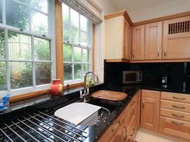 A kitchen with a sink and cabinet at Damson Cottage in Whitby