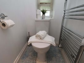 A bathroom with a toilet and towels at Damson Cottage in Whitby