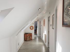 A hallway with doors and paintings at Beachfront in Whitby
