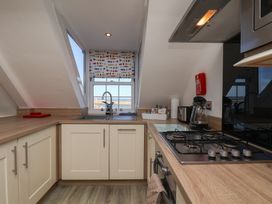 A kitchen with a sink and gas stove at Beachfront in Whitby