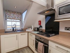 A kitchen with a sink and stove at Beachfront Whitby