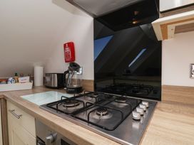 A kitchen with a gas stove and kettle at Beachfront in Whitby