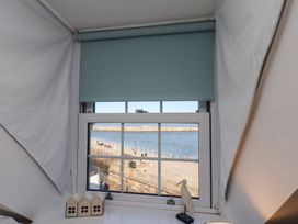 A window with a sea view and decorative items at Beachfront in Whitby