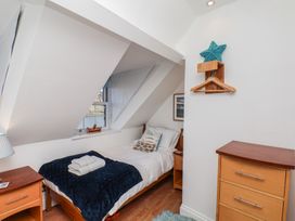 A bedroom with a bed and window at Beachfront in Whitby